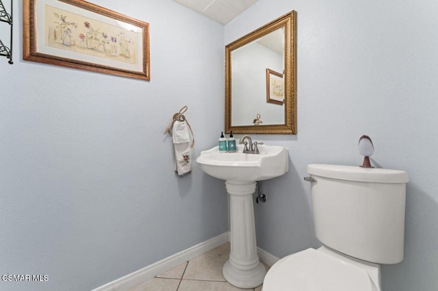 bathroom with toilet and tile patterned floors