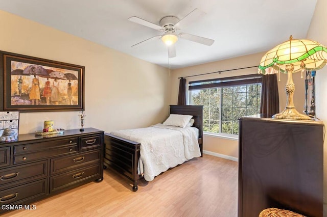 bedroom with ceiling fan and light hardwood / wood-style flooring