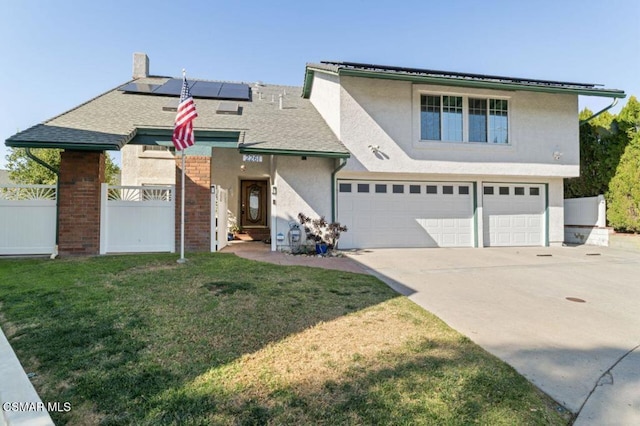 view of front property featuring a front yard, a garage, and solar panels