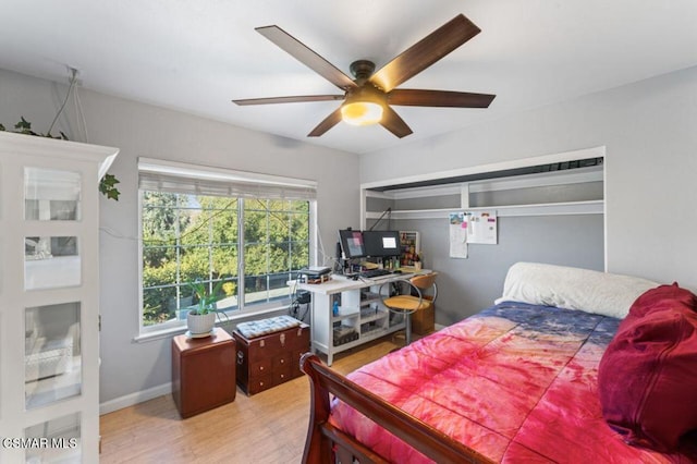 bedroom featuring ceiling fan, a closet, and hardwood / wood-style flooring