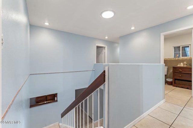 hall with light tile patterned floors