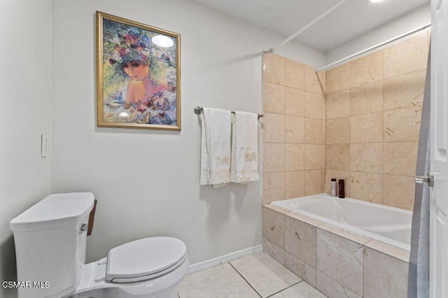 bathroom with tile patterned floors, tiled shower / bath combo, and toilet