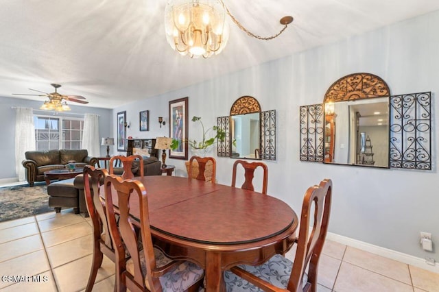 tiled dining area featuring ceiling fan with notable chandelier