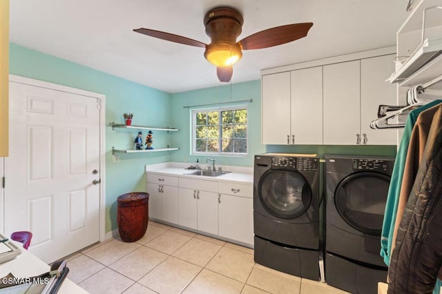 laundry area with ceiling fan, light tile patterned flooring, washing machine and dryer, cabinets, and sink