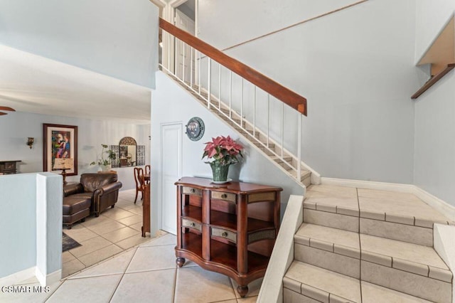 stairway featuring tile patterned flooring