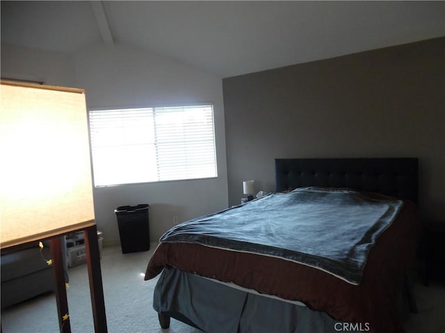 bedroom with lofted ceiling and carpet floors