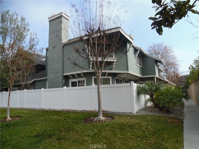 view of home's exterior with a yard