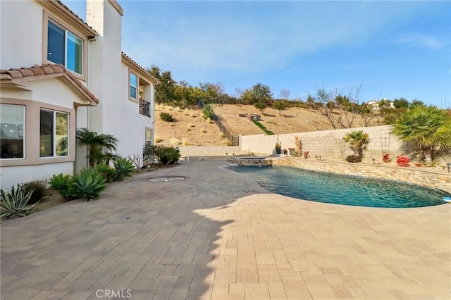 view of swimming pool featuring a patio area, a fenced backyard, and a fenced in pool