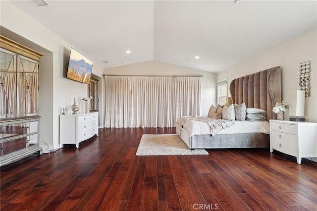 unfurnished bedroom with vaulted ceiling and dark wood-type flooring