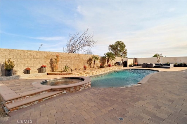 view of swimming pool with an in ground hot tub and a patio area