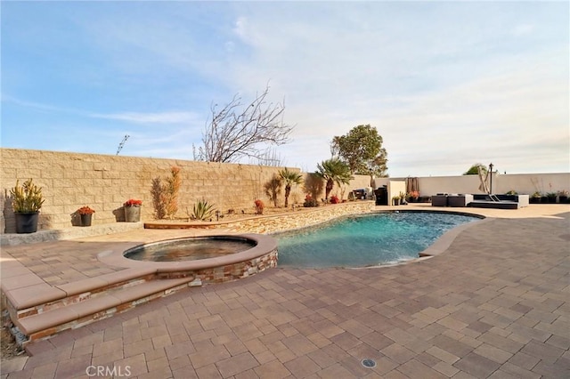 view of swimming pool with an in ground hot tub, a patio area, a fenced backyard, and a fenced in pool