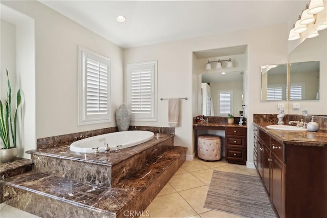 full bath featuring vanity, tile patterned flooring, and a bath