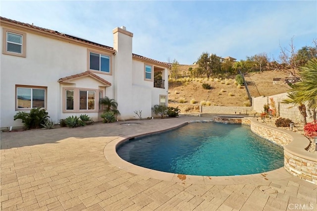 view of pool featuring a patio and a pool with connected hot tub