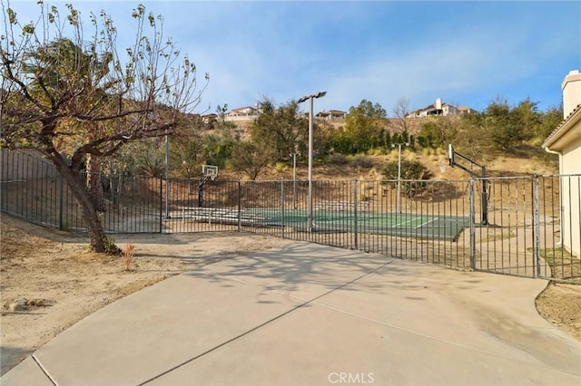 view of gate with a swimming pool