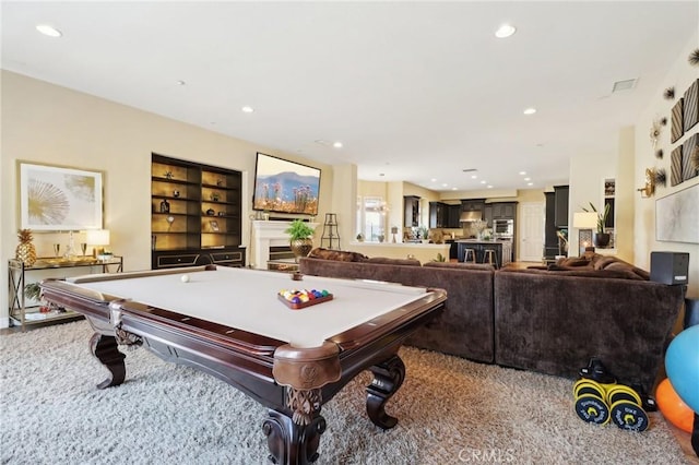 recreation room featuring built in shelves and recessed lighting