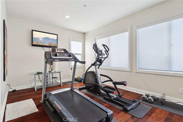 exercise area featuring dark wood-type flooring