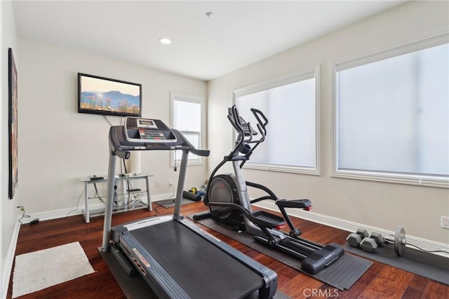 workout room featuring baseboards, wood finished floors, and recessed lighting