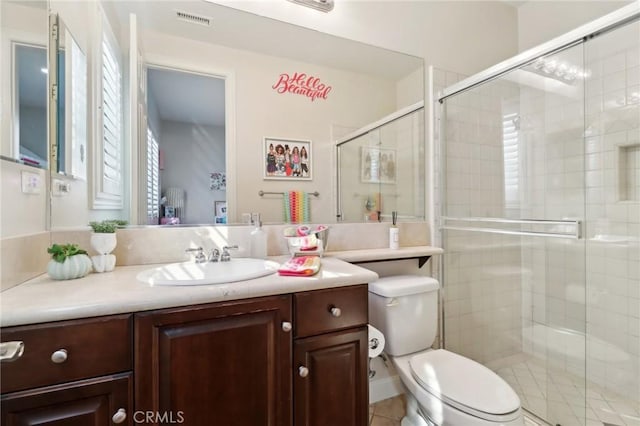 full bath featuring toilet, a stall shower, visible vents, and vanity