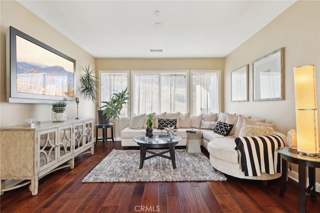 living room with dark wood-style floors and visible vents