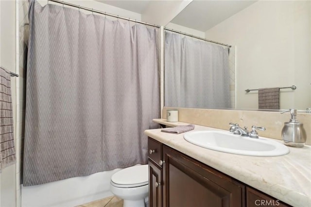 full bathroom featuring tile patterned flooring, vanity, shower / tub combo with curtain, and toilet