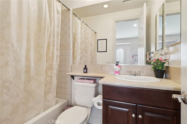 full bathroom with vanity, shower / tub combo, and toilet