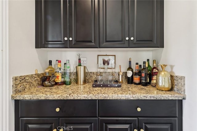 bar featuring light stone countertops