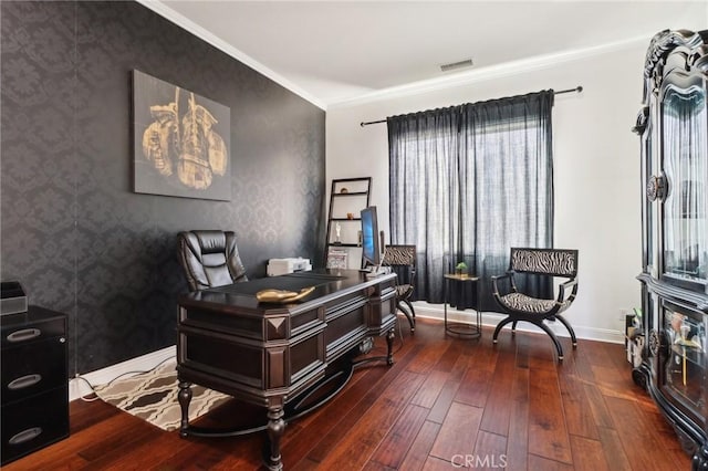 office space with visible vents, baseboards, ornamental molding, wood-type flooring, and wallpapered walls