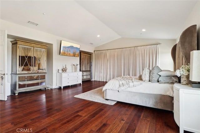 bedroom featuring dark wood-type flooring and vaulted ceiling