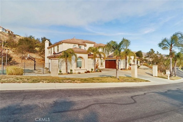 mediterranean / spanish home featuring a garage