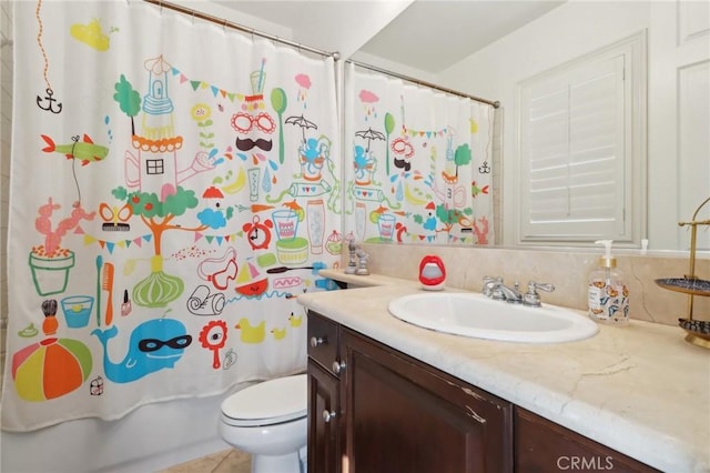 full bathroom with tile patterned flooring, vanity, shower / tub combo with curtain, and toilet