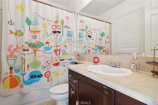 bathroom with toilet, shower / bath combo, and vanity