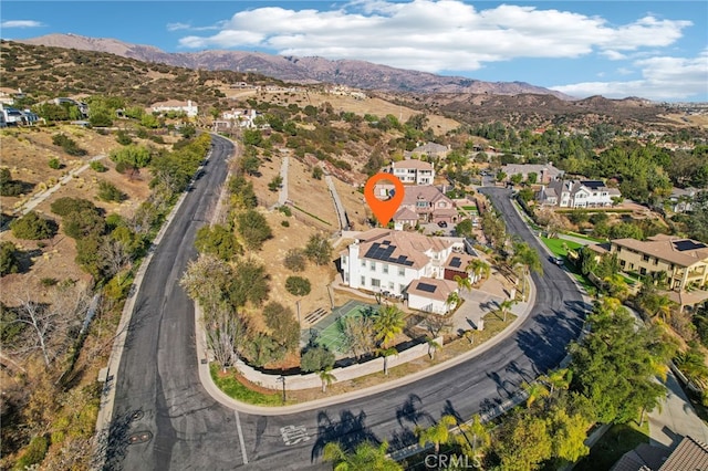 drone / aerial view featuring a residential view and a mountain view