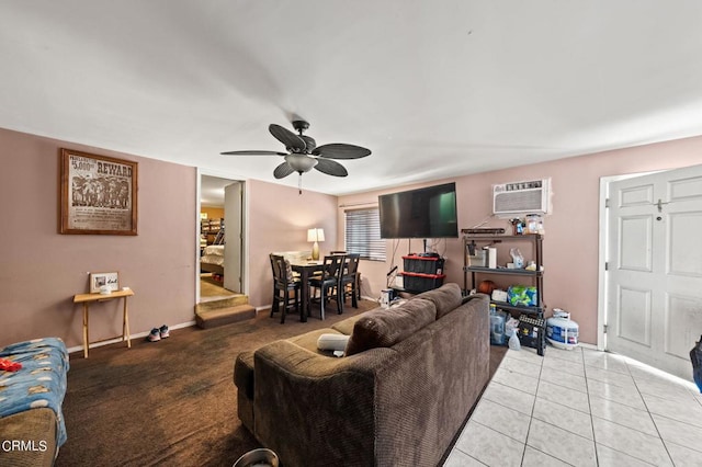 living room with a wall unit AC, ceiling fan, and light tile patterned floors