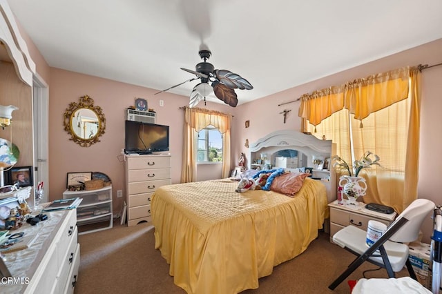 bedroom with ceiling fan and dark colored carpet