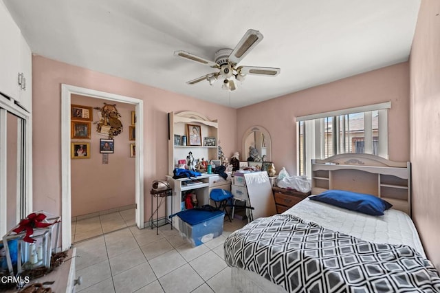 tiled bedroom featuring ceiling fan