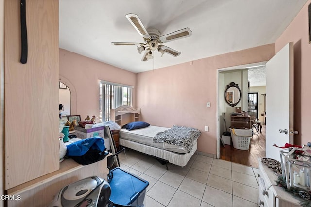 bedroom with ceiling fan and light tile patterned flooring