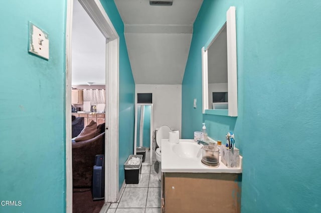 bathroom featuring tile patterned floors, vanity, and toilet