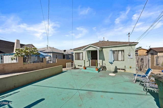 back of house with a patio