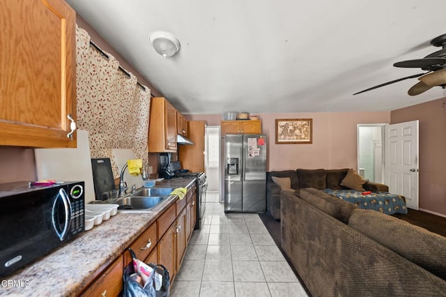 kitchen featuring ceiling fan, light tile patterned floors, appliances with stainless steel finishes, and sink