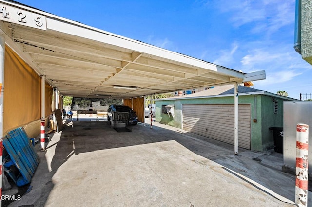 view of vehicle parking featuring a carport and a garage