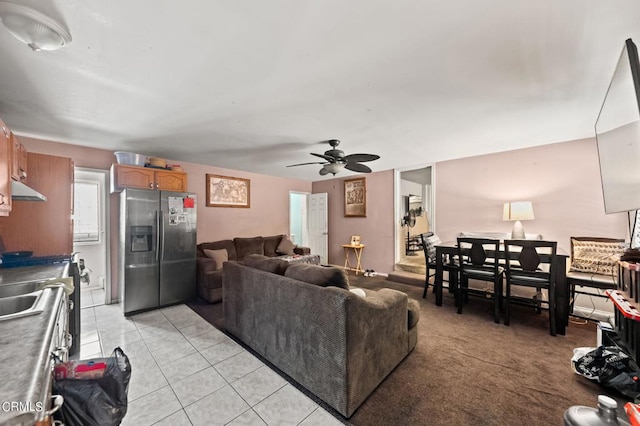 living room featuring ceiling fan and light tile patterned floors