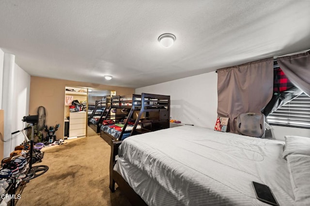 carpeted bedroom with a closet and a textured ceiling