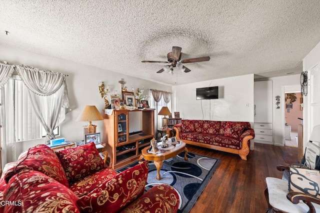 living room featuring a textured ceiling, ceiling fan, and dark hardwood / wood-style floors