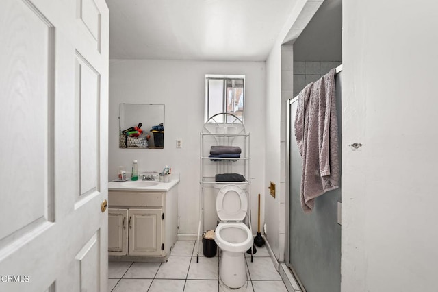 bathroom featuring toilet, tile patterned floors, vanity, and an enclosed shower