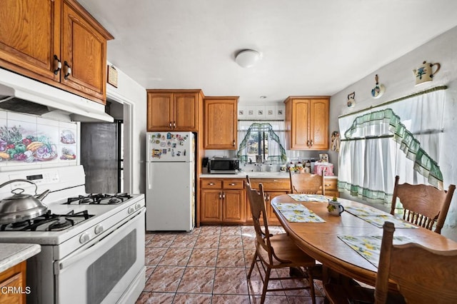 kitchen with light tile patterned flooring and white appliances