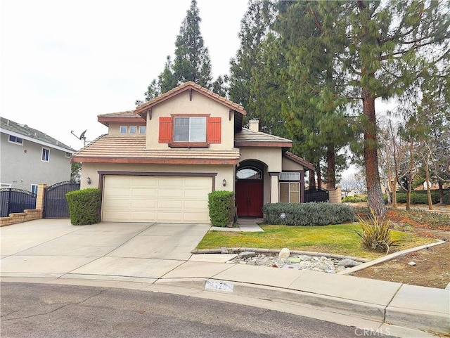 view of front facade with a tile roof, stucco siding, concrete driveway, and a gate