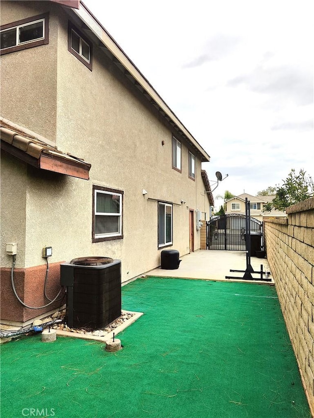 back of property with a patio area and central air condition unit