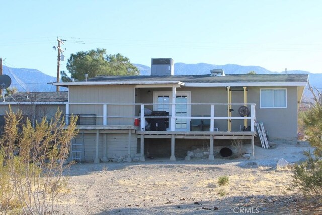 back of property featuring a mountain view