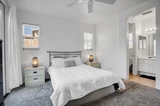 carpeted bedroom featuring ceiling fan and connected bathroom