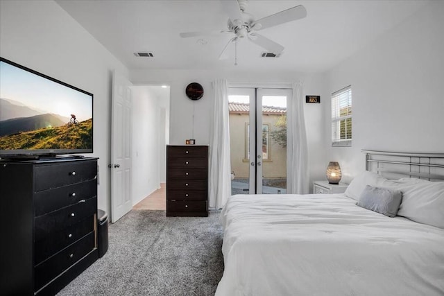 bedroom featuring ceiling fan, light colored carpet, and access to exterior